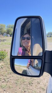 Photo of Maria in the mirror of her van